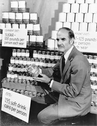 During a press conference in 1977, Sen. George McGovern, chairman of the Senate Nutrition Committee, displayed cans of sodas, sugar and fat that he said represented a person’s average intake for a year.