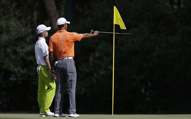 4-time champion Tiger Woods gives some pointers to the youngster, Tianlang Guan.
