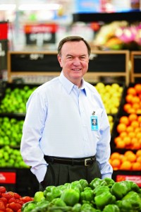 Mike Duke standing among the foods that could help save Walmart save a few billion dollars a year.